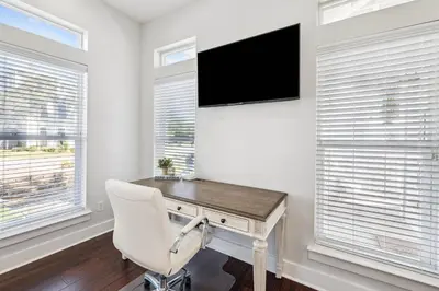 a home office with a desk and a television at Saltwater Therapy on 30A by 30A Escapes in Seacrest