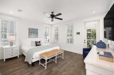 a white bedroom with a bed and a ceiling fan at Seagrove Escape Refreshed plus Shared Pool in Seagrove Beach