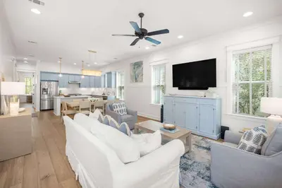 a living room with white furniture and a flat screen tv at Seagrove Escape Refreshed plus Shared Pool in Seagrove Beach