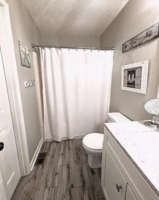 a bathroom with a white toilet and a shower at Shell House of Horizon South in Panama City Beach