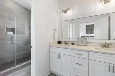 a white bathroom with a sink and a shower at Inlet Beach Retreat Golf Cart Bikes + Pool in Inlet Beach