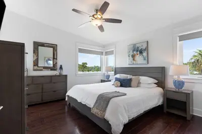 a bedroom with a bed and a ceiling fan at Inlet Beach Retreat Golf Cart Bikes + Pool in Inlet Beach