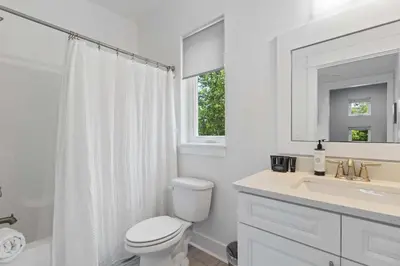 a white bathroom with a toilet and a sink at Inlet Beach Retreat Golf Cart Bikes + Pool in Inlet Beach