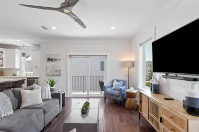 a living room with a large flat screen tv at Inlet Beach Retreat Golf Cart Bikes + Pool in Inlet Beach
