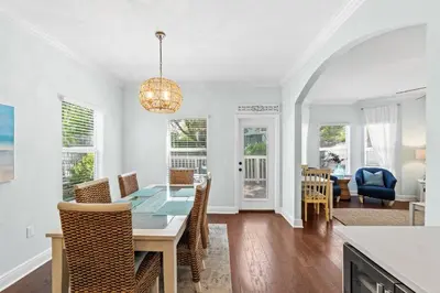 a dining room and living room with a table and chairs at Family Friendly Vacation Rental at 30Ave Beach Retreat in Inlet Beach in Rosemary Beach