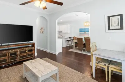 a living room with a flat screen tv and a dining room at Family Friendly Vacation Rental at 30Ave Beach Retreat in Inlet Beach in Rosemary Beach