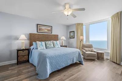 a bedroom with a bed and a ceiling fan at Emerald Beach 1631 by Emerald Coast Retreats in Panama City Beach