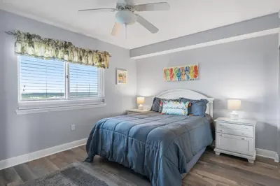 a bedroom with a bed and a ceiling fan at Emerald Beach 1631 by Emerald Coast Retreats in Panama City Beach