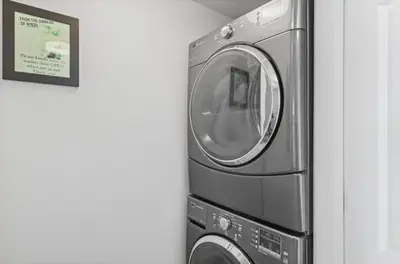 a washer and dryer sitting next to a wall at Emerald Beach 1631 by Emerald Coast Retreats in Panama City Beach