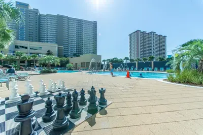 a giant chess board in front of a pool at Emerald Beach 1631 by Emerald Coast Retreats in Panama City Beach