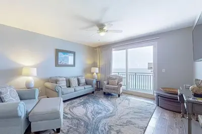 a living room with a couch and chairs and a window at Sterling Breeze 1207 by Emerald Coast Retreats in Panama City Beach