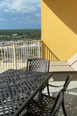 a black metal table and chair on a balcony at Calypso III Stunning Oceanview next to Pier Park Mall in Panama City Beach