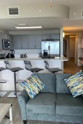a living room with a couch and a kitchen at Calypso III Stunning Oceanview next to Pier Park Mall in Panama City Beach