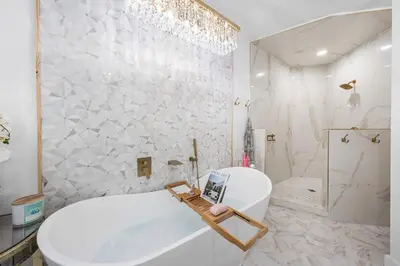 a white bathroom with a tub and a sink at Southern Charm 409, Village of South Walton in Rosemary Beach