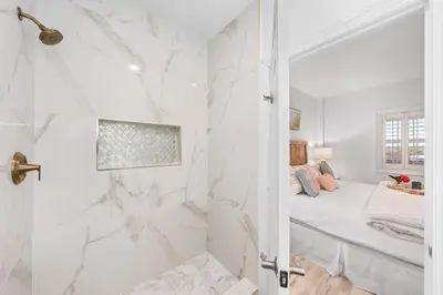 a white bathroom with a shower and a bed at Southern Charm 409, Village of South Walton in Rosemary Beach