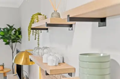 a room with a shelf with mugs on it at Village of SoWal B203 in Rosemary Beach