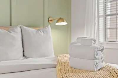 a stack of towels sitting on top of a bed at Village of SoWal B203 in Rosemary Beach