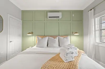 a bedroom with a white bed with towels on it at Village of SoWal B203 in Rosemary Beach