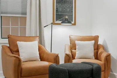 two chairs and a ottoman in a living room at Village of SoWal B257 in Rosemary Beach