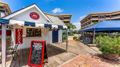 a restaurant with a sign on a wooden deck at Village of SoWal B257 in Rosemary Beach