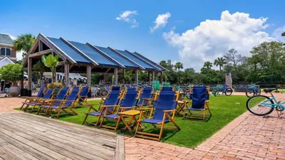 a group of chairs sitting on the grass at Village of SoWal B257 in Rosemary Beach