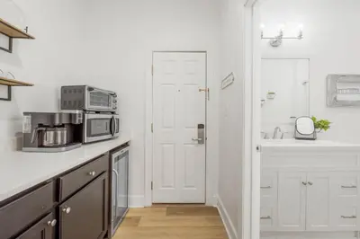 a kitchen with a microwave and a sink at Village of SoWal B257 in Rosemary Beach