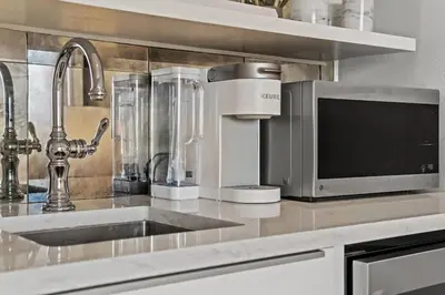 a kitchen counter with a sink and a microwave at Inn at Seacrest Beach 409 in Inlet Beach