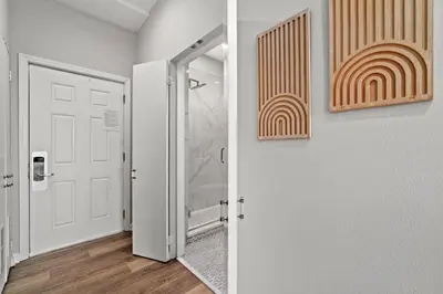 a hallway with a shower and a white door at Inn at Seacrest Beach 409 in Inlet Beach