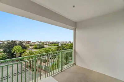 a balcony with a view of a park at Inn at Seacrest Beach 409 in Inlet Beach