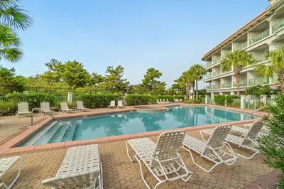 a swimming pool with lounge chairs and a hotel at Inn at Seacrest Beach 409 in Inlet Beach