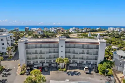 an aerial view of a building with the ocean in the background at Inn at Seacrest Beach 409 in Inlet Beach