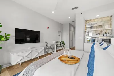 a living room with a white couch and a table at Inn at Seacrest Beach 409 in Inlet Beach