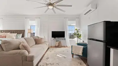 a living room with a couch and a ceiling fan at Village of SoWal B483 in Rosemary Beach
