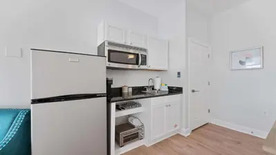 a kitchen with a refrigerator and a microwave at Village of SoWal B483 in Rosemary Beach