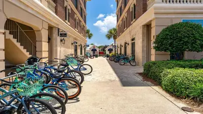 a row of bikes parked on a sidewalk next to buildings at Village of SoWal B483 in Rosemary Beach
