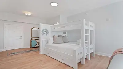 a white bedroom with a white bunk bed at Village of SoWal B483 in Rosemary Beach