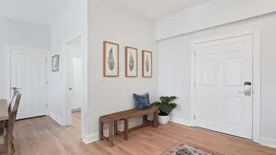 a white room with a wooden table and a door at Village of SoWal B483 in Rosemary Beach