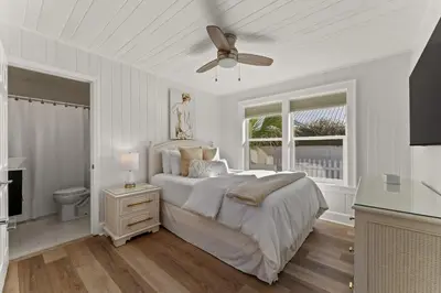 a white bedroom with a bed and a ceiling fan at 9620 Beach Blvd in Panama City Beach
