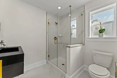 a bathroom with a toilet and a glass shower at 9620 Beach Blvd in Panama City Beach