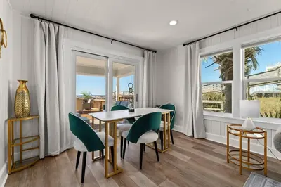 a dining room with a table and chairs at 9620 Beach Blvd in Panama City Beach
