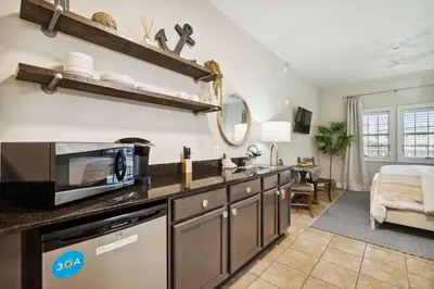 a kitchen with a microwave oven and a sink at Village of SoWal B204 in Rosemary Beach