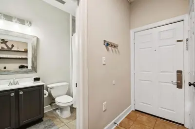 a white bathroom with a toilet and a sink at Village of SoWal B204 in Rosemary Beach