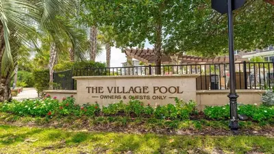a sign for the village pool on a building at Village of SoWal B204 in Rosemary Beach