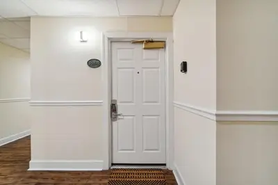 a hallway with a white door in a room at Village of SoWal B204 in Rosemary Beach