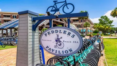 a sign for a bike shop with bikes parked at Village of SoWal B204 in Rosemary Beach