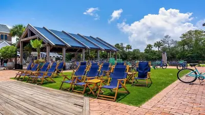 a group of chairs sitting on the grass at Village of SoWal B204 in Rosemary Beach
