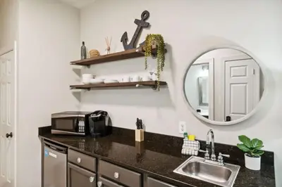 a kitchen with a sink and a mirror at Village of SoWal B204 in Rosemary Beach
