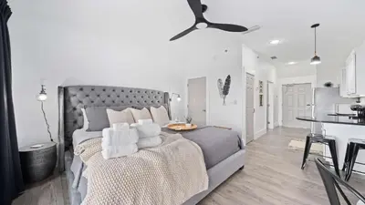 a white bedroom with a bed with towels on it at Inn at Seacrest Beach 408 in Rosemary Beach