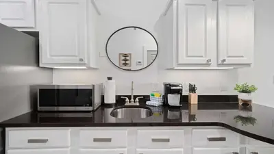 a white kitchen with a sink and a mirror at Inn at Seacrest Beach 408 in Rosemary Beach