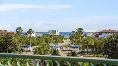 a balcony with a view of a town and the ocean at Inn at Seacrest Beach 408 in Rosemary Beach